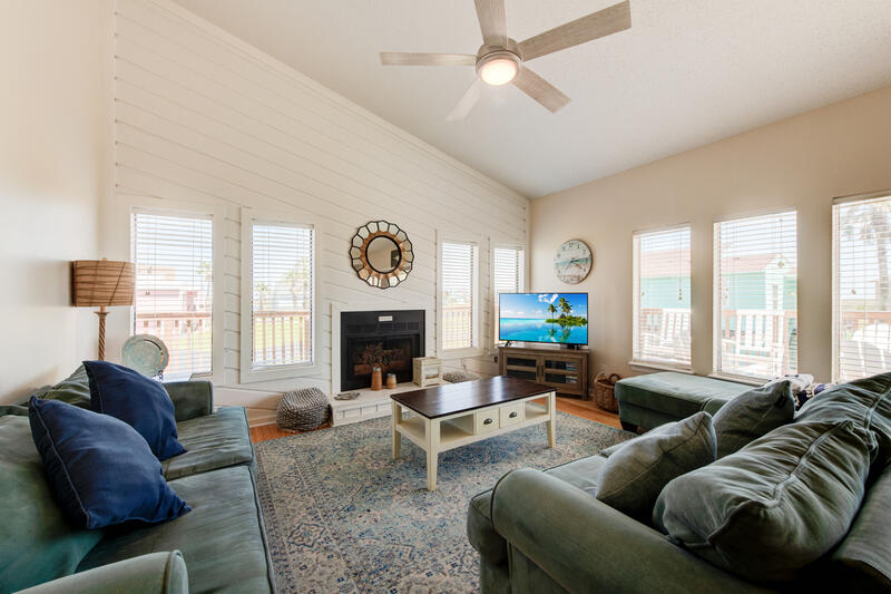 Main-floor living room with sofas and TV