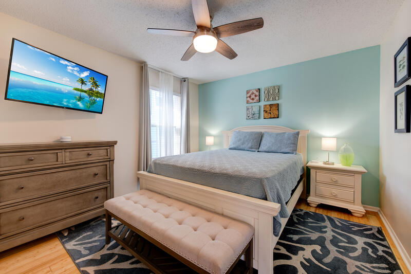 Bedroom with king bed, dresser and TV